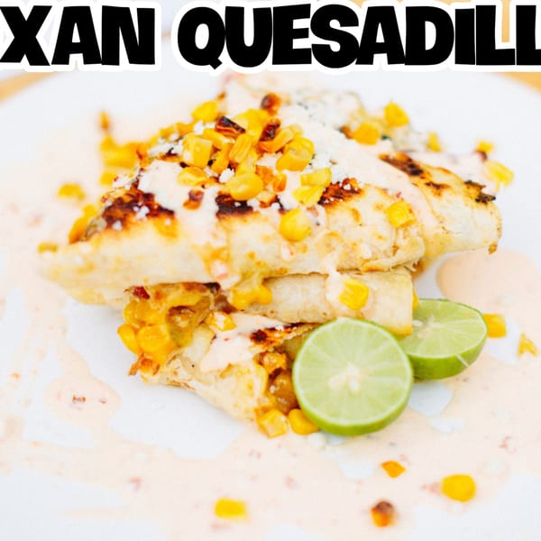 Blacktop Grill's quesadillas topped with corn, cheese, and sauce, garnished with lime wedges.