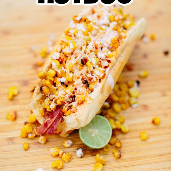 Elote hot dog from The Blacktop Grill, topped with corn, cheese, chili powder, and a lime.