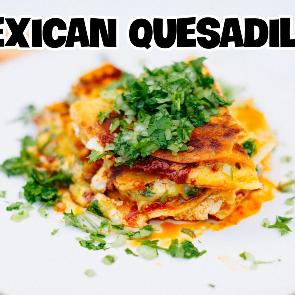 Golden-brown quesadillas, generously topped with fresh cilantro and a rich red sauce, on a white plate.